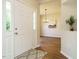 Inviting foyer with hardwood floors and view into dining room with chandelier at 1010 Starita Ct, Apex, NC 27502