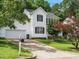 A charming white home with a two-car garage and a long driveway at 1010 Starita Ct, Apex, NC 27502