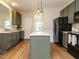 Updated kitchen featuring an island, painted cabinets, and modern pendant lighting at 1010 Starita Ct, Apex, NC 27502