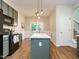 Updated kitchen with island, painted cabinets, and adjacent dining area at 1010 Starita Ct, Apex, NC 27502