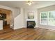 Open-concept living room with fireplace and wood flooring at 1010 Starita Ct, Apex, NC 27502
