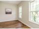 Bright living room featuring hardwood floors and ample natural light at 1010 Starita Ct, Apex, NC 27502