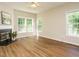 Bright living room with fireplace, large windows, and wood flooring at 1010 Starita Ct, Apex, NC 27502