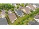 An aerial view of the home and surrounding neighborhood featuring lush greenery and manicured lawns at 1012 Autumn Meadow Ln, Wake Forest, NC 27587