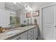 Bright bathroom featuring a double vanity with granite countertop and framed mirror at 1012 Autumn Meadow Ln, Wake Forest, NC 27587