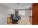 Cozy bonus room with striped chairs, plush rug, and natural light from the window at 1012 Autumn Meadow Ln, Wake Forest, NC 27587