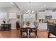 Open dining room with wood floors, a chandelier, a dark wood table with seating for six, and views to the kitchen at 1012 Autumn Meadow Ln, Wake Forest, NC 27587
