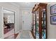 Bright entryway featuring a decorative display cabinet, light hardwood flooring, and a door to the home office at 1012 Autumn Meadow Ln, Wake Forest, NC 27587
