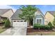 Charming home featuring a two-car garage, manicured landscaping, and lovely curb appeal at 1012 Autumn Meadow Ln, Wake Forest, NC 27587