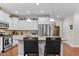 Spacious kitchen features stainless appliances, pendant lights over the island, and access to the dining room at 1012 Autumn Meadow Ln, Wake Forest, NC 27587