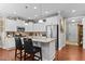 Bright, airy kitchen with stainless steel appliances, a kitchen island, and white cabinets with decorative décor at 1012 Autumn Meadow Ln, Wake Forest, NC 27587