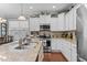 Bright kitchen with stainless steel appliances, granite countertops, white cabinets, and a view to the dining room at 1012 Autumn Meadow Ln, Wake Forest, NC 27587