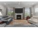 Inviting living room with fireplace, plush sofas, and a view of the outside patio at 1012 Autumn Meadow Ln, Wake Forest, NC 27587