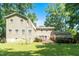 Spacious backyard with a deck, offering a serene outdoor space surrounded by mature trees and lush greenery at 1015 Manchester Dr, Cary, NC 27511