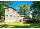 Lush backyard with a spacious lawn, mature trees, and deck, offering a private and tranquil outdoor setting at 1015 Manchester Dr, Cary, NC 27511