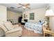 Comfortable bedroom with a ceiling fan and sitting area at 1015 Manchester Dr, Cary, NC 27511