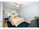 Cozy bedroom with natural light, ceiling fan, and stylish decor with a wooden floor at 1015 Manchester Dr, Cary, NC 27511
