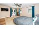 Sunlit bedroom with light walls, a ceiling fan, and french doors to the outside at 1015 Manchester Dr, Cary, NC 27511