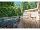 Large wooden deck with furniture overlooks lush greenery, providing an ideal spot for outdoor gatherings at 1015 Manchester Dr, Cary, NC 27511