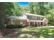 Charming two-story home featuring stone accents, a covered porch, mature landscaping, and a well-manicured lawn at 1015 Manchester Dr, Cary, NC 27511