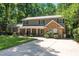 Two-story home with a covered porch, stone and siding exterior, and driveway leading to the entrance at 1015 Manchester Dr, Cary, NC 27511