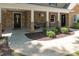 Inviting covered front porch with stone columns, hanging flower baskets, and a seating area at 1015 Manchester Dr, Cary, NC 27511