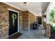 Inviting front porch with stone accents, seating, and decorative wreaths on the doors at 1015 Manchester Dr, Cary, NC 27511