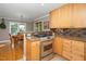 Open-concept kitchen featuring a stainless steel range, granite counters, and ample cabinet space at 1015 Manchester Dr, Cary, NC 27511
