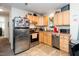 This kitchen features stainless steel appliances, light cabinets, and a view to the carpeted living area at 1015 Manchester Dr, Cary, NC 27511