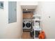 Functional laundry area featuring washer, dryer, and storage shelves in the hallway at 1015 Manchester Dr, Cary, NC 27511