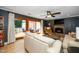Cozy living room with stone fireplace, fan, neutral furniture, and access to an outdoor deck at 1015 Manchester Dr, Cary, NC 27511