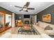 Comfortable living room with fireplace, ceiling fan and access to a deck via sliding glass doors at 1015 Manchester Dr, Cary, NC 27511