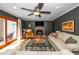 Inviting living room featuring a fireplace, ceiling fan, and sliding doors to a deck at 1015 Manchester Dr, Cary, NC 27511