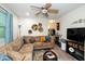 Bright living room featuring a sectional sofa, colorful rug, and a modern entertainment center at 1015 Manchester Dr, Cary, NC 27511