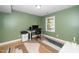 Bright home office with hardwood floors, a large desk, and natural light at 1015 Manchester Dr, Cary, NC 27511
