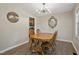 Cozy dining room featuring hardwood floors, stylish chandelier, and classic wooden table with matching chairs at 105 Tactical Dr, Bunnlevel, NC 28323
