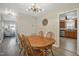 Inviting dining area with wood floors, chandelier, and table with chairs, opening to the living room and kitchen at 105 Tactical Dr, Bunnlevel, NC 28323