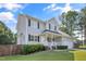 Beautifully maintained two-story home featuring a manicured lawn and a cozy, covered front porch at 105 Tactical Dr, Bunnlevel, NC 28323