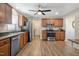 Well-lit kitchen with stainless steel appliances, wooden cabinetry, and durable flooring, offering a functional design at 105 Tactical Dr, Bunnlevel, NC 28323