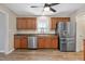 Modern kitchen with stainless steel appliances, hardwood cabinets, and laminate floors, providing ample storage at 105 Tactical Dr, Bunnlevel, NC 28323