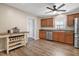 Well-lit eat-in kitchen features stainless appliances, wood cabinets, modern countertops, and stylish flooring at 105 Tactical Dr, Bunnlevel, NC 28323
