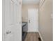 Functional laundry room with modern washer and dryer, ample storage, and convenient access to the exterior at 105 Tactical Dr, Bunnlevel, NC 28323