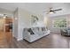 Comfortable living room featuring a plush sofa, ceiling fan, and an open doorway leading to the kitchen at 105 Tactical Dr, Bunnlevel, NC 28323