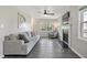 Cozy living room with a large sofa, a fireplace, and bright windows, creating an inviting and relaxing space at 105 Tactical Dr, Bunnlevel, NC 28323