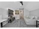 Large living room space, featuring a couch, tv, modern ceiling fan and neutral colored carpet at 105 Tactical Dr, Bunnlevel, NC 28323
