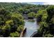 Aerial view of a serene river flowing through lush, green trees under a clear sky at 10518 Pleasant Branch Dr # 38, Raleigh, NC 27614