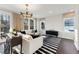 Bright living room with a modern chandelier, neutral curtains, and a striking black and white striped rug at 10518 Pleasant Branch Dr # 38, Raleigh, NC 27614