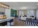 Stylish living room featuring white sofas, a black-and-white striped rug, and seamless access to kitchen at 10518 Pleasant Branch Dr # 38, Raleigh, NC 27614