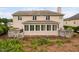 Back of the home with a sunroom, a deck with a hot tub, and landscaping at 111 Gingergate Dr, Cary, NC 27519