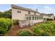 Back of the home with a sunroom, a deck with a hot tub, and landscaping at 111 Gingergate Dr, Cary, NC 27519